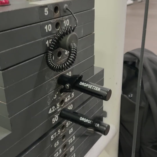 Two Dropsetters popping out of a weight stack mid-set