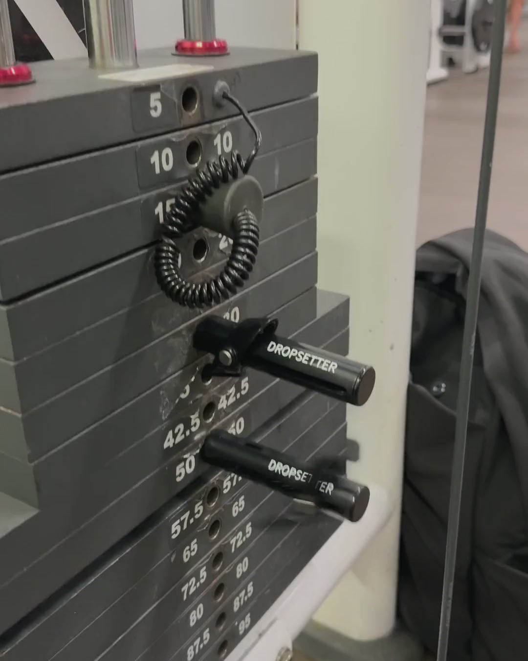 Two Dropsetters popping out of a weight stack mid-set
